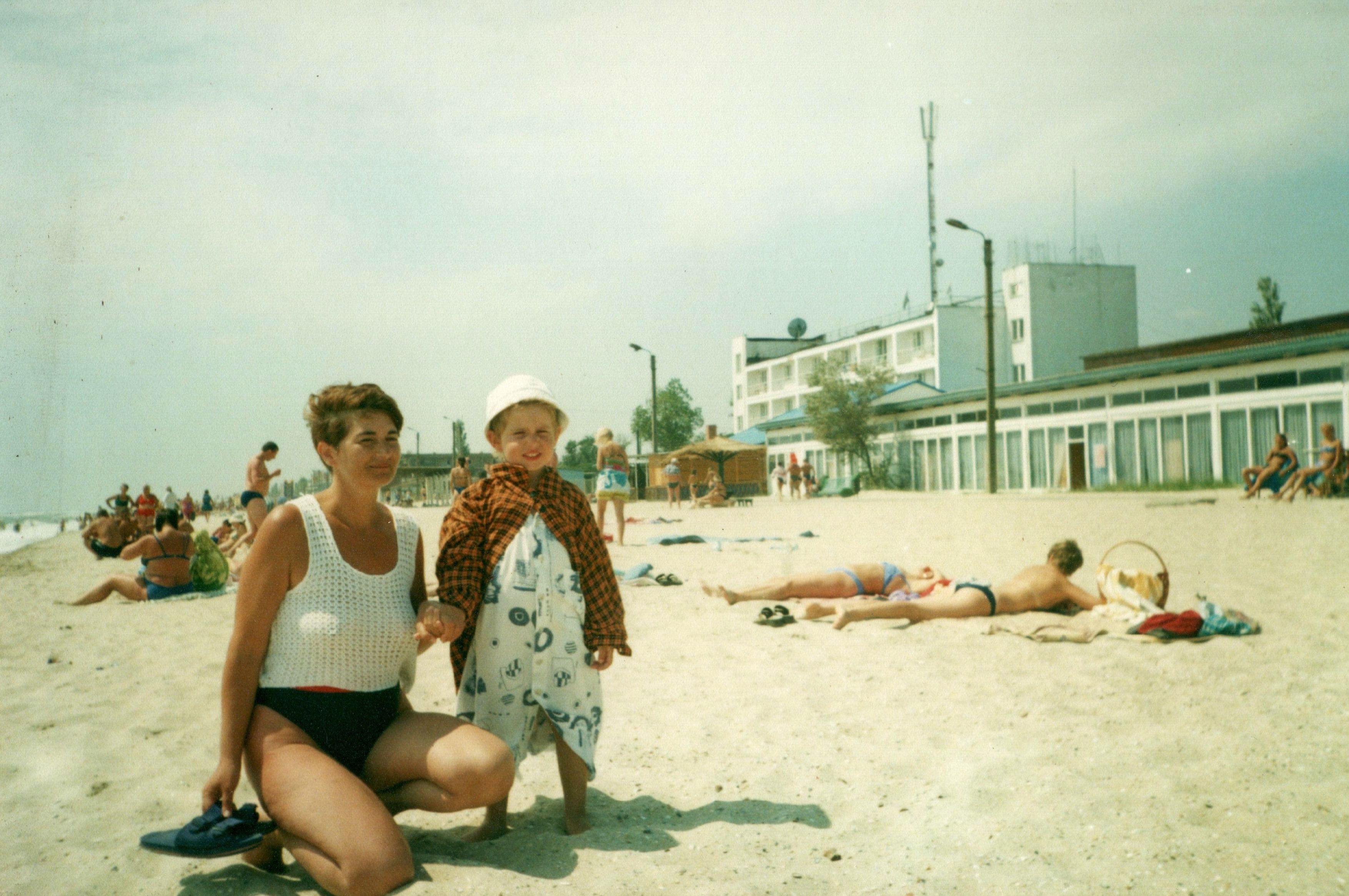 A mother and child at the beach, faded photograph