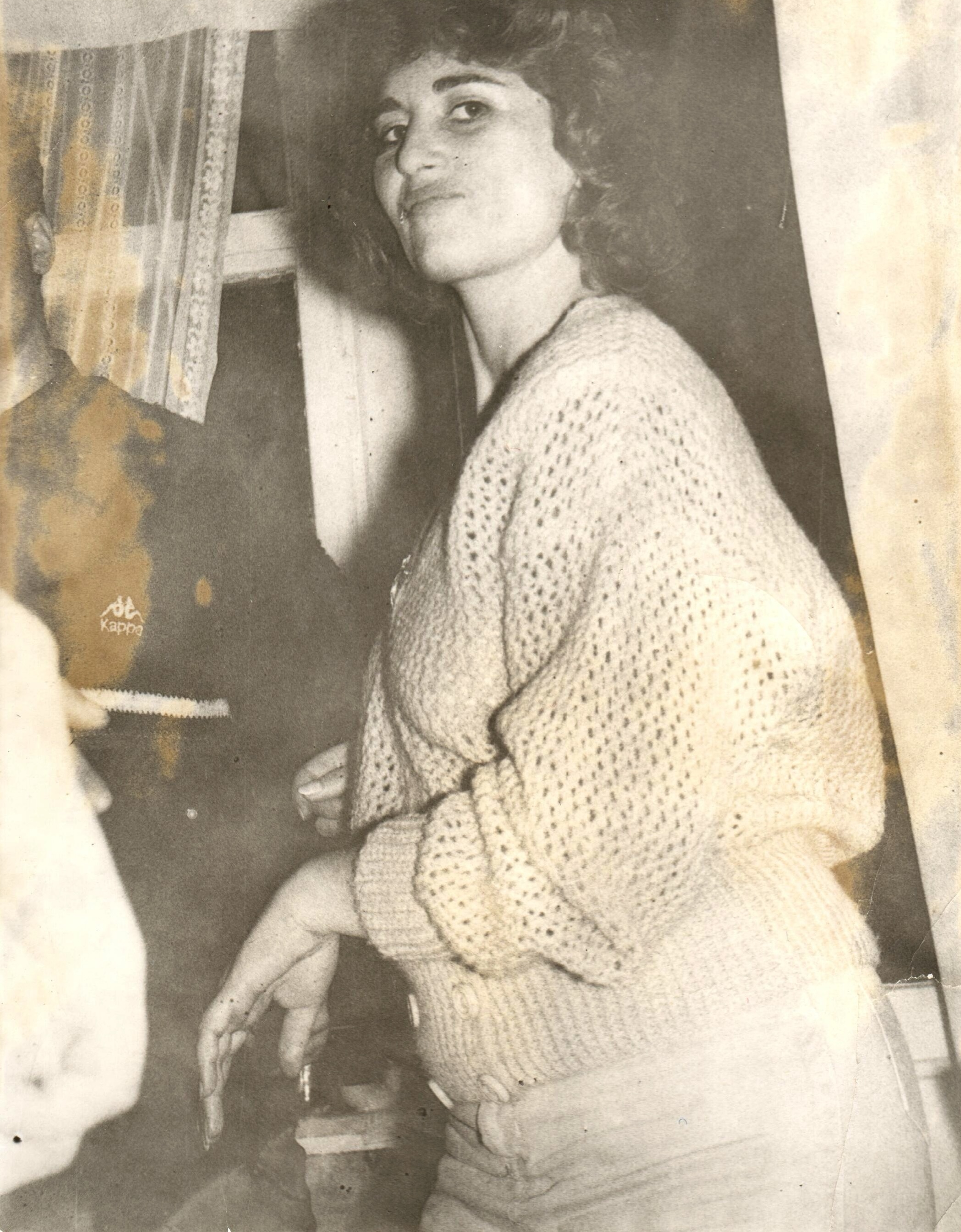 A faded, water-stained photograph before restoration